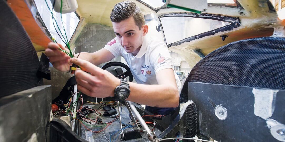 Technical student working on a car